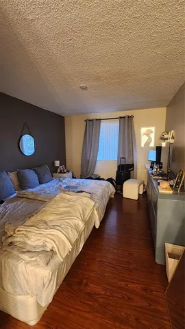 a bedroom with a bed and a potted plant