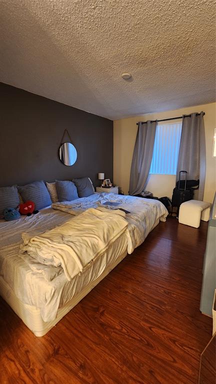 3874 Lyons Road, Unit 103 Pompano Beach, FL 33073 - Photo 16 of 27 a bedroom with a bed and a potted plant