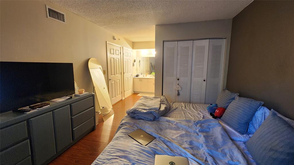 3874 Lyons Road, Unit 103 Pompano Beach, FL 33073 - Photo 17 of 27 a living room with furniture and a flat screen tv