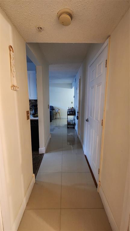 3874 Lyons Road, Unit 103 Pompano Beach, FL 33073 - Photo 20 of 27 a view of a hallway with seating area