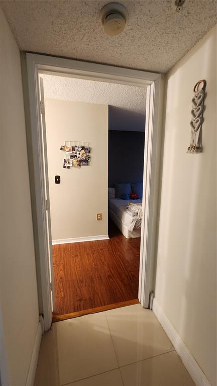 3874 Lyons Road, Unit 103 Pompano Beach, FL 33073 - Photo 21 of 27 a view of hallway with wooden floor