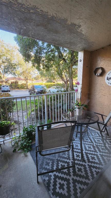 3874 Lyons Road, Unit 103 Pompano Beach, FL 33073 - Photo 24 of 27 a view of a two chairs in the patio