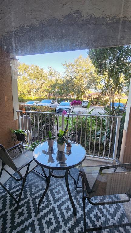 3874 Lyons Road, Unit 103 Pompano Beach, FL 33073 - Photo 25 of 27 a view of a chairs and table in patio
