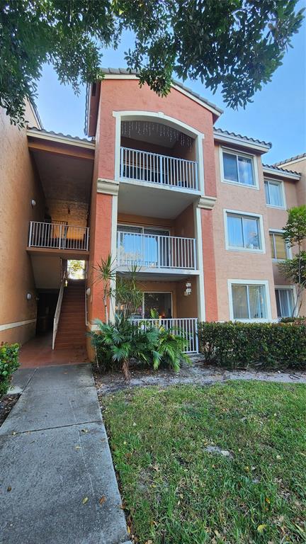 3874 Lyons Road, Unit 103 Pompano Beach, FL 33073 - Photo 26 of 27 a view of a yard in front of a house