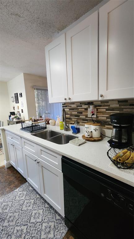 3874 Lyons Road, Unit 103 Pompano Beach, FL 33073 - Photo 5 of 27 a kitchen with a sink a stove and cabinets
