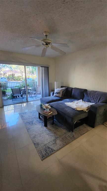 3874 Lyons Road, Unit 103 Pompano Beach, FL 33073 - Photo 10 of 27 a living room with furniture and a rug