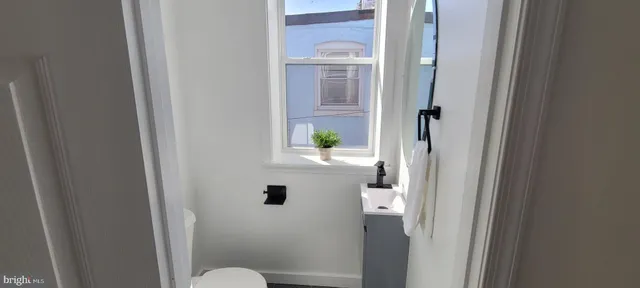 a kitchen with kitchen island a sink stainless steel appliances and a counter top space