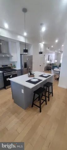 a living room with furniture a flat screen tv and a toilet