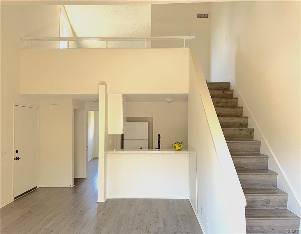 a view of a hallway with wooden floor and entryway
