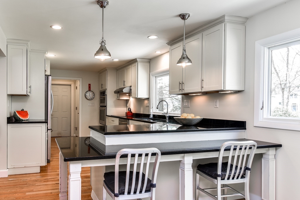 2 Hilltop Road Dover, MA 02030 - Photo 9 of 23 a kitchen with stainless steel appliances granite countertop a stove a sink and a refrigerator with wooden floor