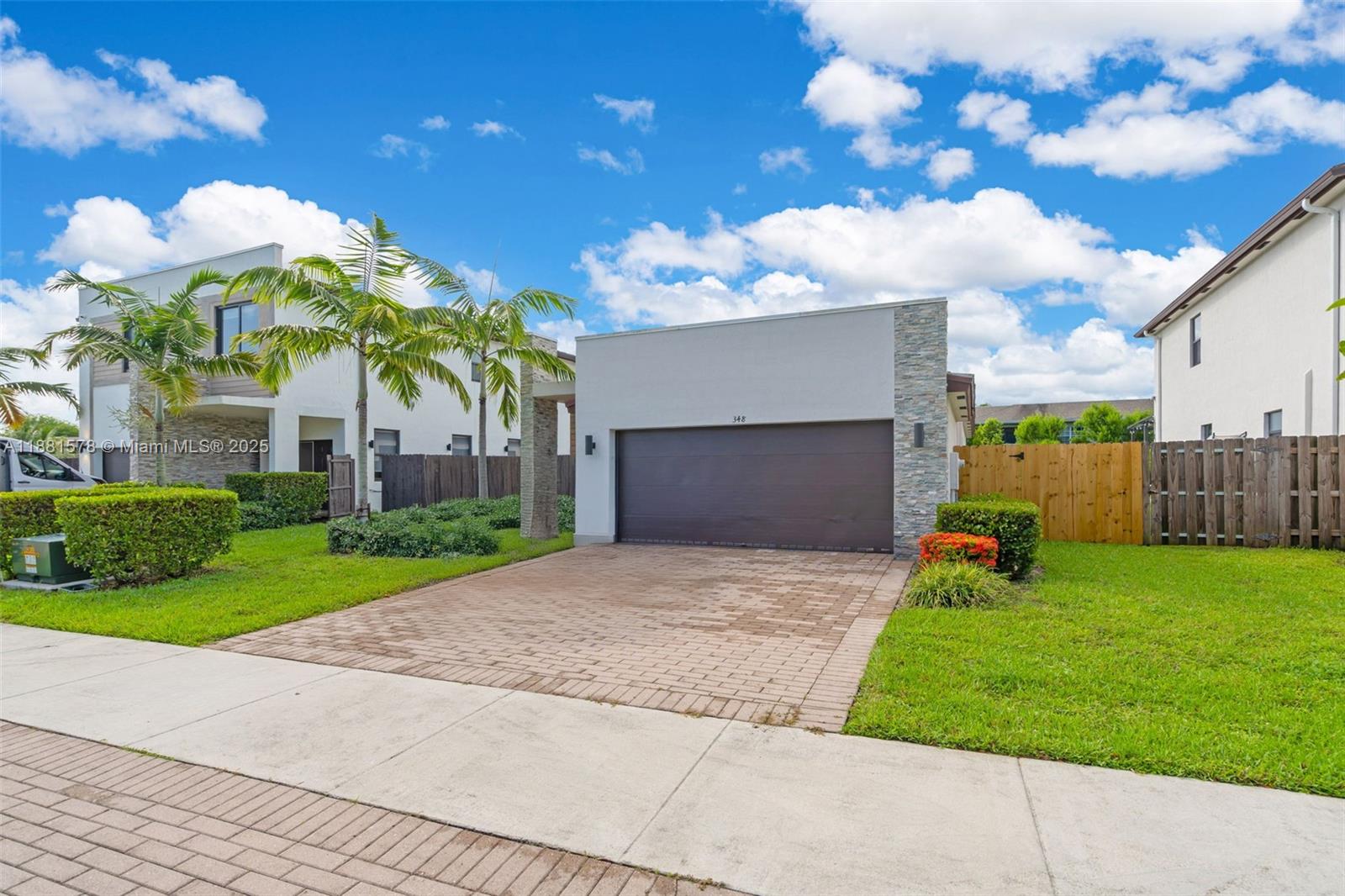 Ives Estates Miami, FL 33179 - Photo 2 of 25 a front view of a house with a yard and garage