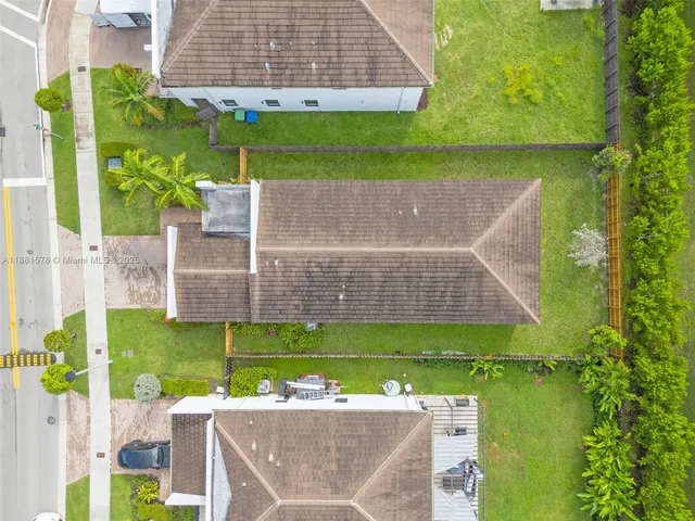 an aerial view of a house with a garden and trees