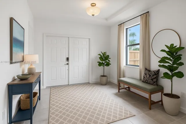 a living room with furniture and a potted plant