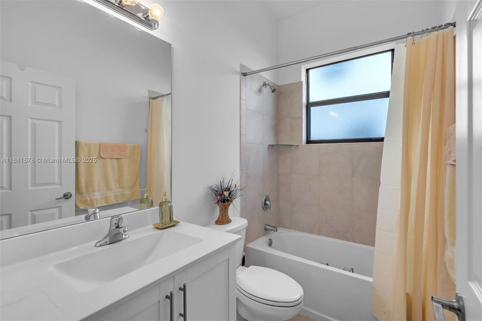 Ives Estates Miami, FL 33179 - Photo 6 of 25 a bathroom with a bathtub shower sink vanity and toilet