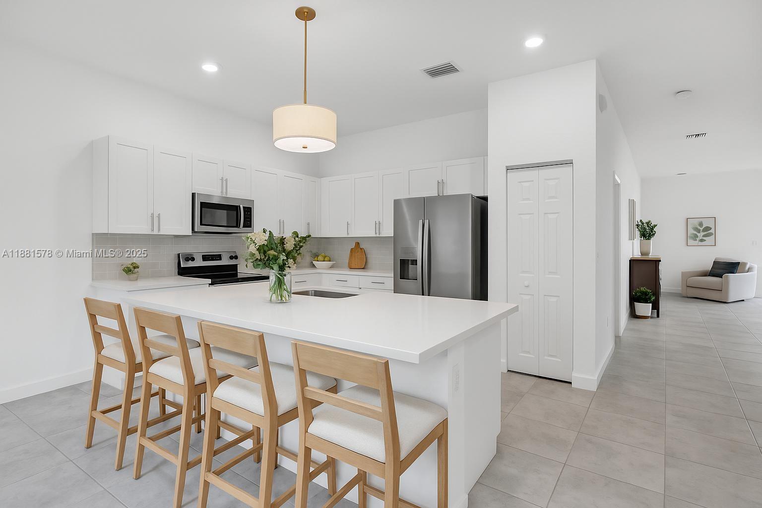 Ives Estates Miami, FL 33179 - Photo 8 of 25 a kitchen with stainless steel appliances a refrigerator a stove a sink dishwasher and a refrigerator with wooden floor