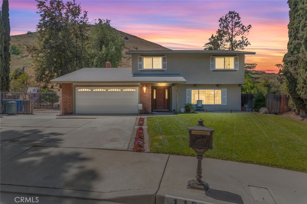 11291 Platte Drive Riverside, CA 92505 - Photo 1 of 1 Twilight sets over a tranquil two-story home with a lush lawn and picturesque mountain backdrop.