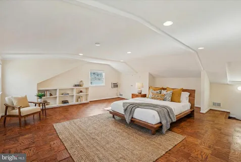 wooden floor fireplace and windows in an empty room