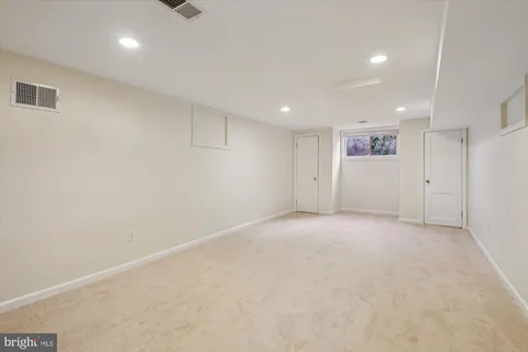a view of an empty room with a kitchen