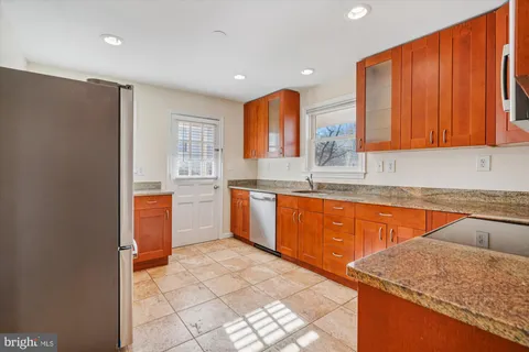 a kitchen with stainless steel appliances granite countertop a sink and cabinets