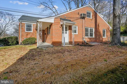 a view of a backyard with large trees