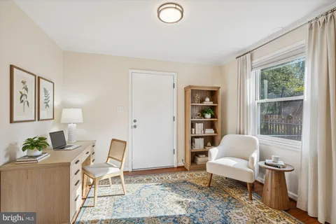 a bedroom with a bed a table and a window