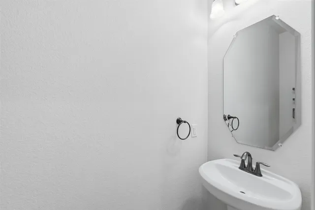 a bathroom with a sink and mirror