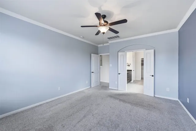 a view of a livingroom with a ceiling fan and window