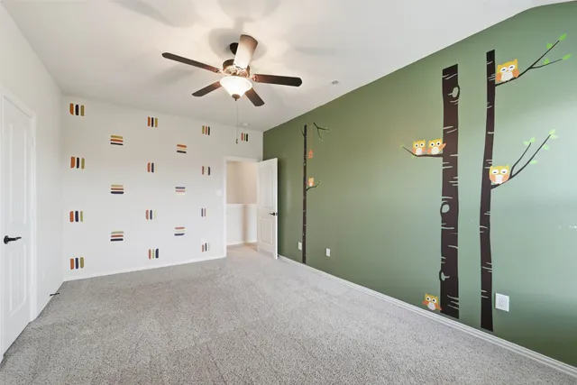 a view of a livingroom with a ceiling fan and window