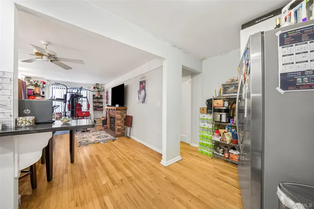 a view of a play room with furniture and a flat screen tv