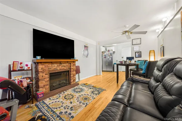 a living room with furniture a flat screen tv and a fireplace