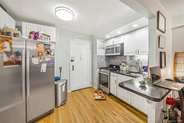 a kitchen with stainless steel appliances granite countertop a refrigerator and a sink