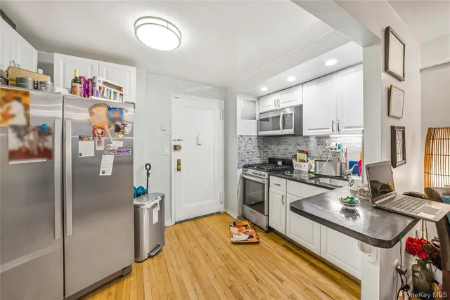 a kitchen with stainless steel appliances granite countertop a refrigerator and a sink