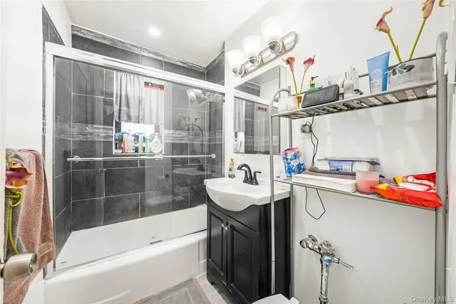 a bathroom with a sink mirror toilet and bathtub