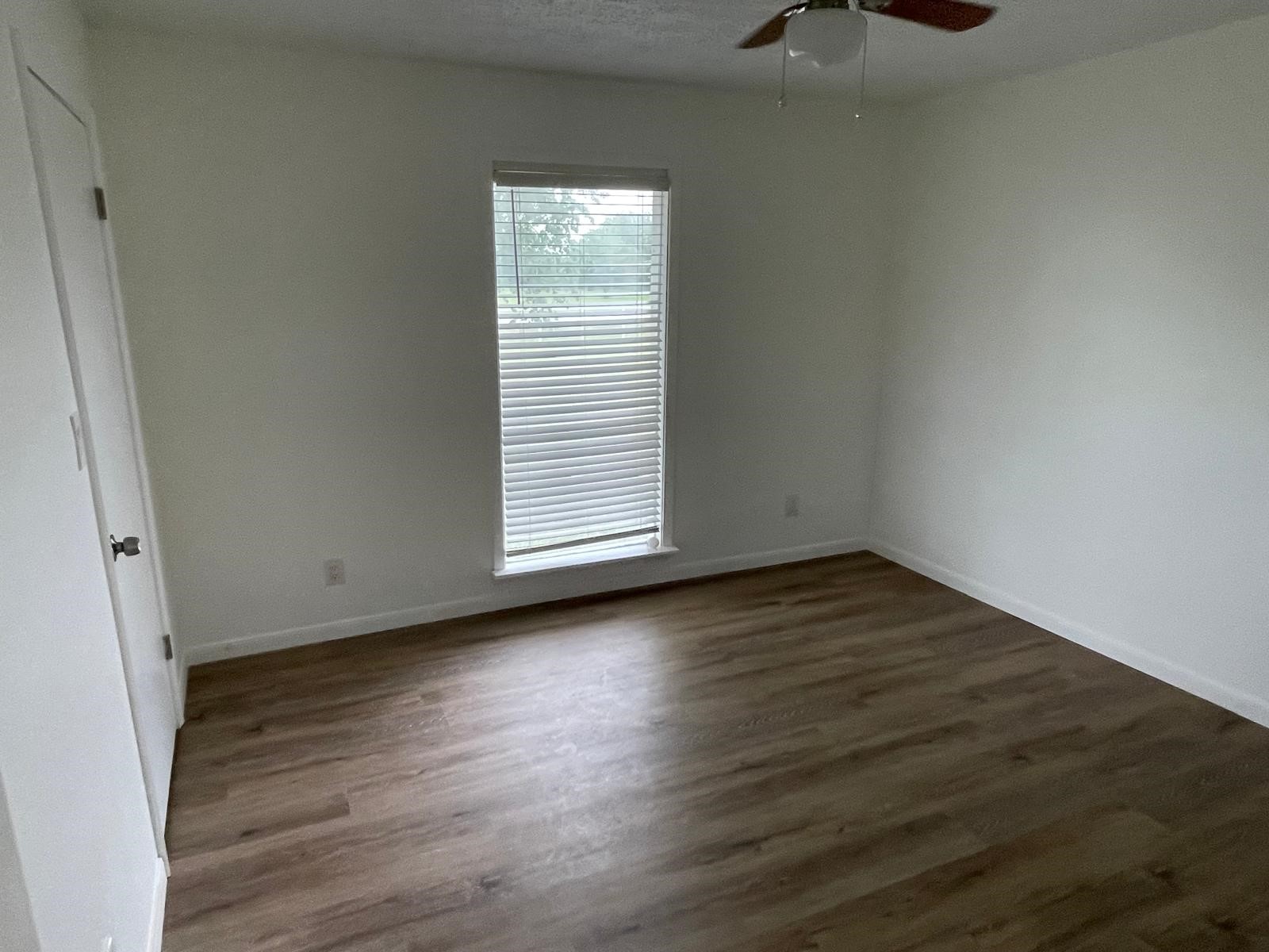 335 Carroll Road Richmond, TX 77469 - Photo 19 of 25 an empty room with wooden floor and windows