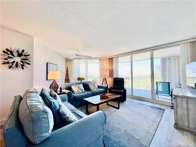 a view of a chairs and table in the balcony