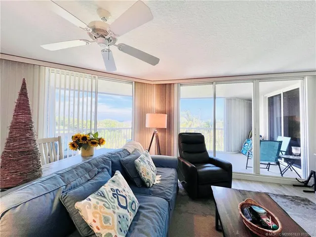 a view of a balcony with furniture and a potted plants