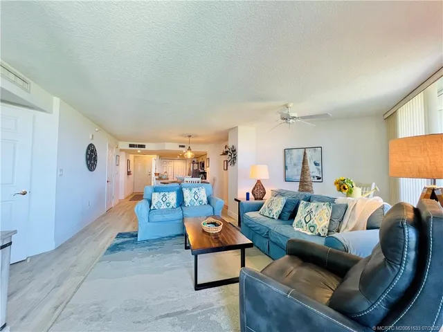 a view of a chairs and table on the balcony