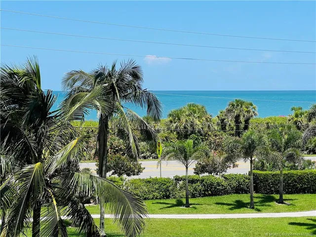 a bedroom with two beds and ceiling fan