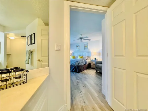 a view of a patio with dining table and chairs with wooden floor