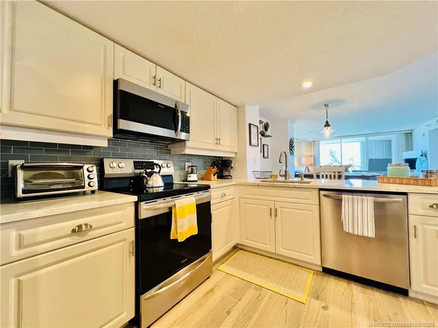 a living room with furniture and large windows