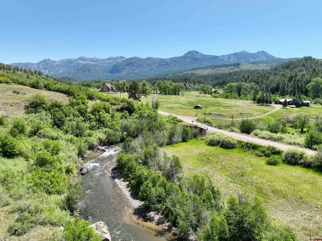 a view of a lush green hillside and houses