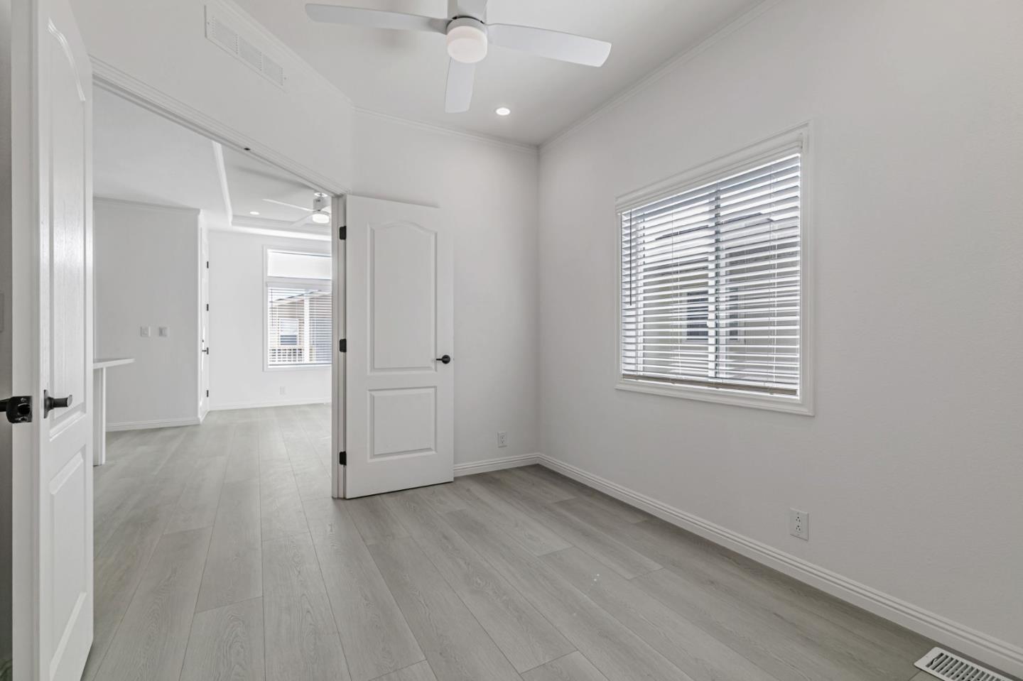 555 Umbarger Road, Unit 131 San Jose, CA 95111 - Photo 17 of 32 an empty room with wooden floor and windows