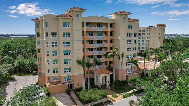 a front view of a building with a garden and plants