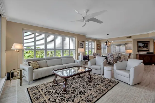 a living room with furniture a rug a lamp and a table
