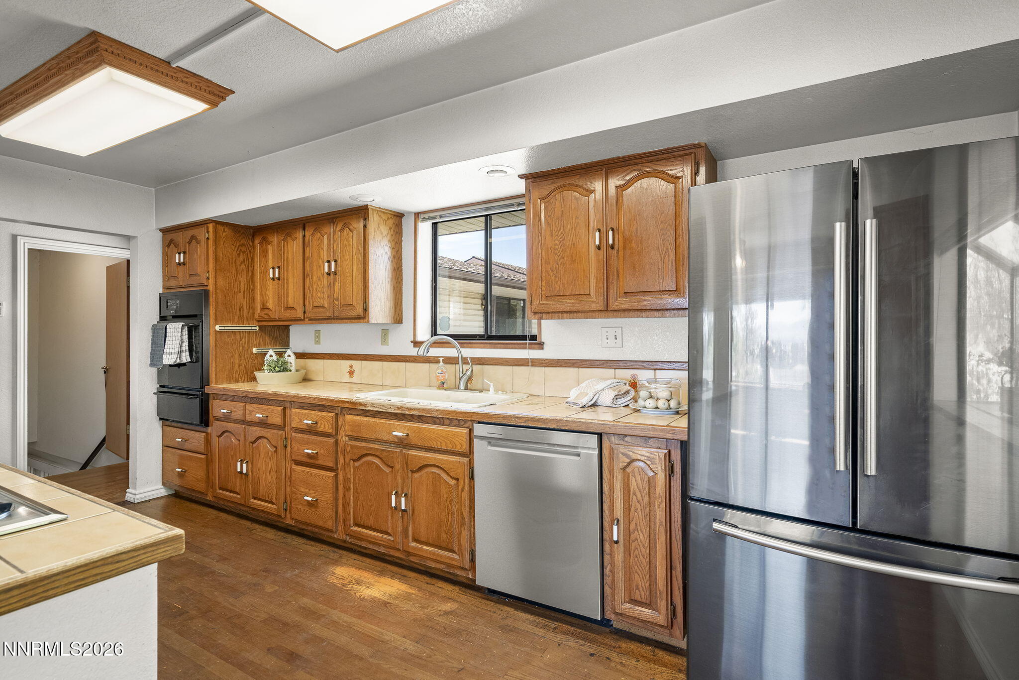 2985 Socrates Drive Reno, NV 89512 - Photo 9 of 52 a kitchen with stainless steel appliances granite countertop a refrigerator a sink and a stove