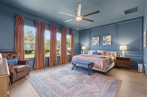 a living room with a bed furniture and a large window
