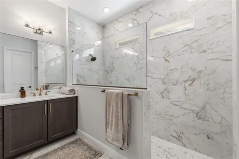 a bathroom with a shower sink and mirror