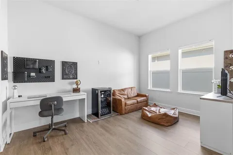a view of a livingroom with workspace and a window
