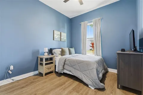 a bedroom with a bed and a tv