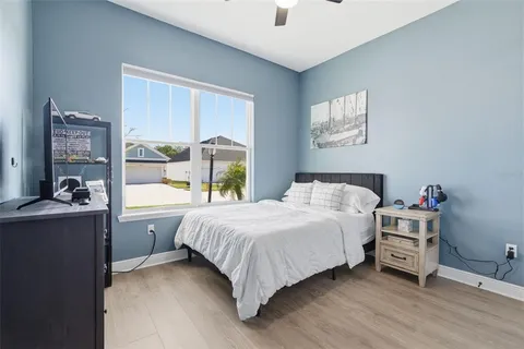 a bedroom with a bed and a large window